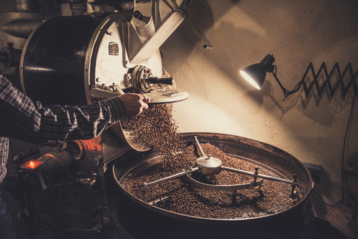 Biji kopi dituang ke mesin sangrai saat proses sangrai batch kecil Kopi Nusa